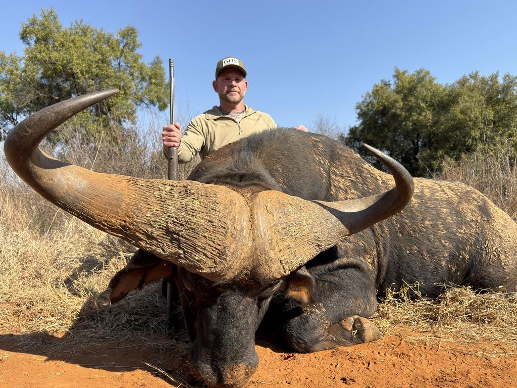 Hunter with Cape buffalo on an African safari